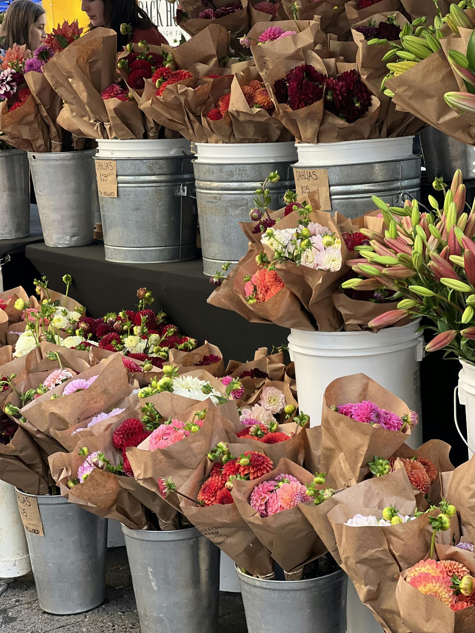 Charming display of colorful flower bouquets at an outdoor market stall.